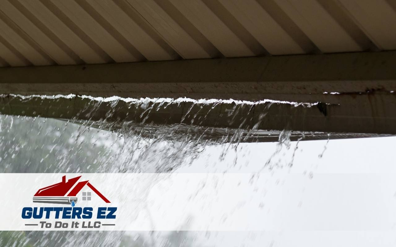 Water leaking from a cracked gutter during rainfall