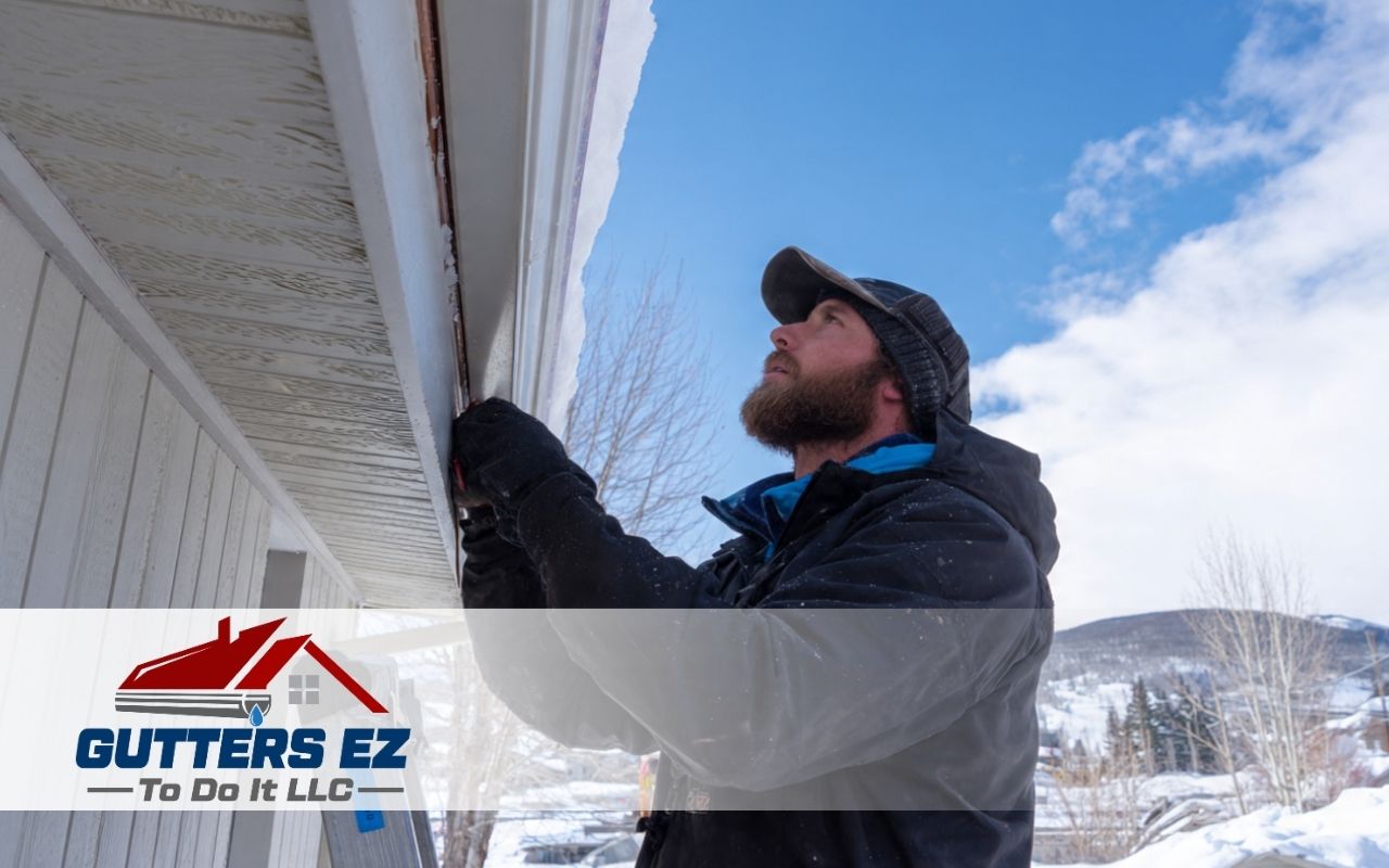 Copper Gutters Winter Performance with snow and ice along a roof edge on a suburban home.
