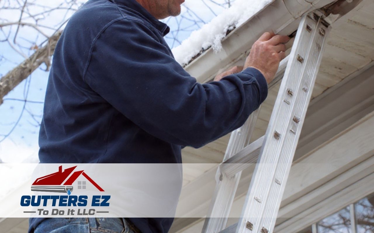 Homeowner performing Freeze-Thaw Gutter Damage Prevention inspection on winter gutters