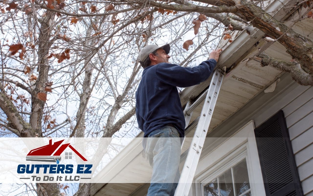 Homeowner using a ladder to inspect gutters as part of a Winter Gutter Maintenance Checklist